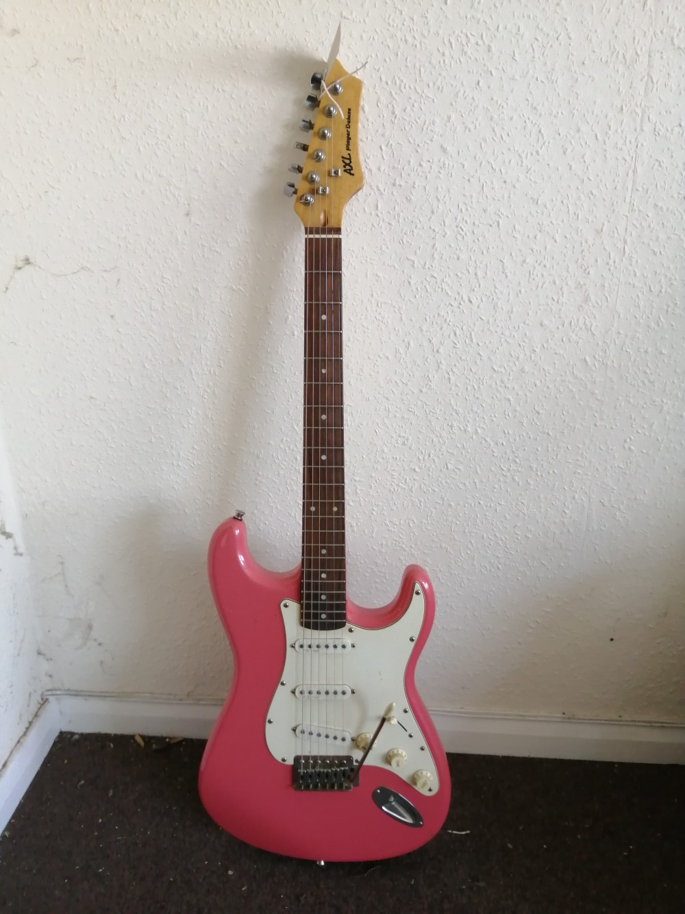 An AXL Player Deluxe electric guitar